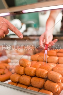 Customer Buying Sausages At Butchery