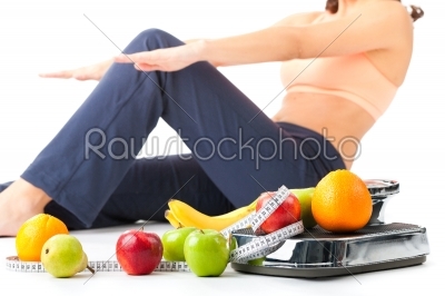 Diet and sport - young woman is doing sit-ups 