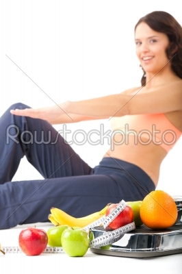 Diet and sport - young woman is doing sit-ups