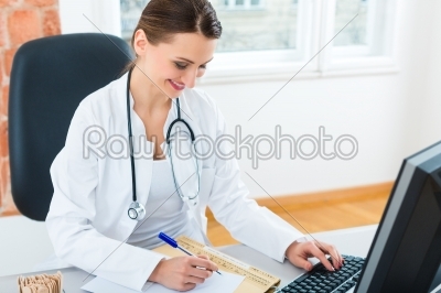 doctor at desk in clinic writing a file or dossier
