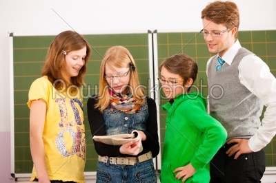 Education - Pupils with teacher on blackboard at school