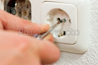 Electrician installing socket