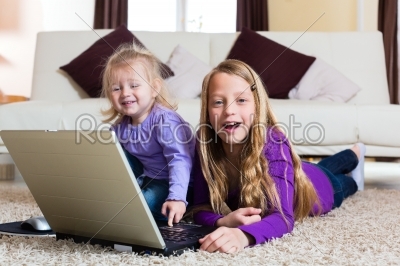 Family - child playing with the laptop