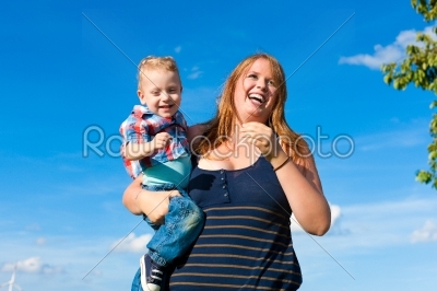 Family - mother and child playing in garden