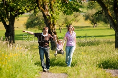 Family having a walk outdoors in summer