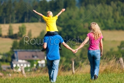 Family having walk on meadow
