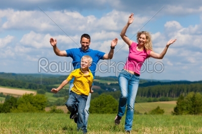 Family having walk on meadow