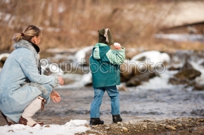 Family having winter walk at river