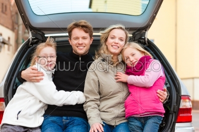Family on a car trip sitting in the back