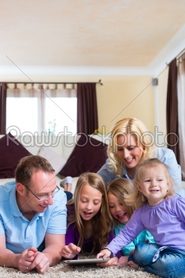 Family playing with Tablet computer at home