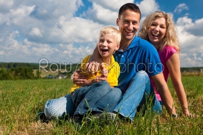 Family sitting on meadow 