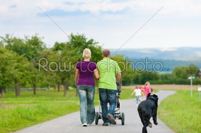 Family with children and dog having walk