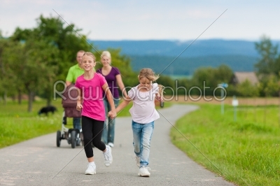 Family with children and dog having walk