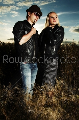 Fashion man and woman in field