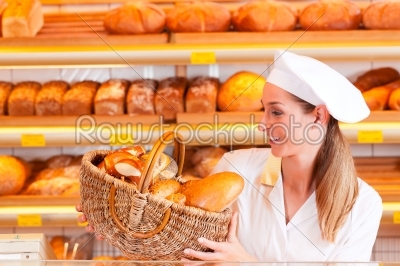 Female baker selling bread in her bakery