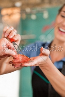 Female Butcher Selling Fresh Meat to Customer