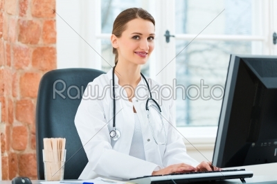 Female doctor writing in document