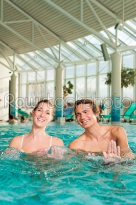 Fitness - gymnastics under water in swimming pool