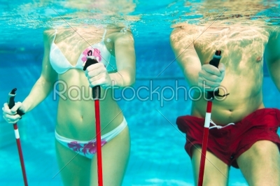 Fitness - sports and gymnastics under water in swimming pool or spa