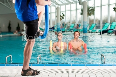 Fitness - sports gymnastics under water in swimming pool