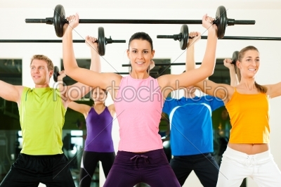 Fitness group with barbell in gym