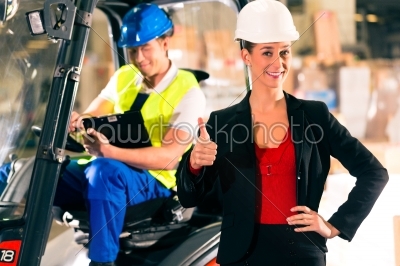 Forklift driver and supervisor at warehouse