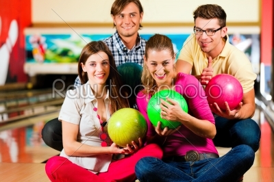 Friends bowling together