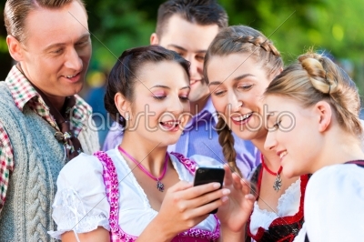 Friends in Beer garden with smartphone