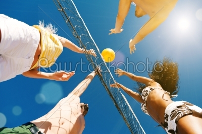 Friends playing beach volleyball