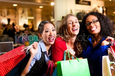 Friends shopping with bags in mall