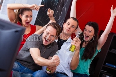 Friends watching exciting game at TV