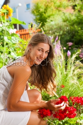 Garden in summer - happy woman with flowers
