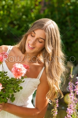Garden in summer - happy woman with flowers