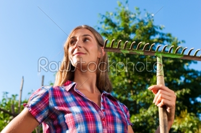 Gardening in summer - woman with grate