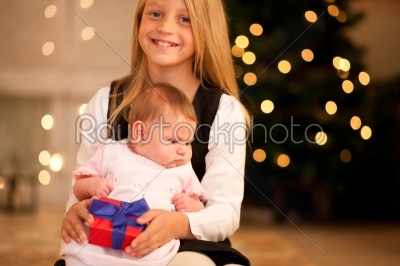 Girl and sister baby at Christmas