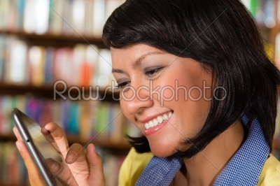 Girl at library reading a e-book