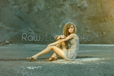 Girl fashion posing on a rock