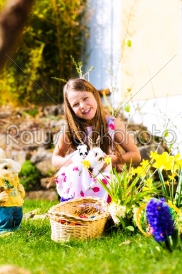 Girl on Easter egg hunt with living Easter Bunny