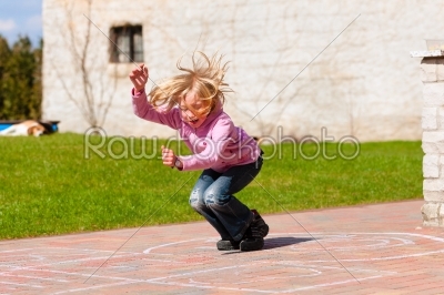 Girl playing in spring garden having fun