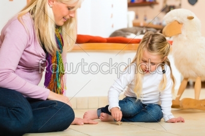 Girl playing with wooden toy spinner