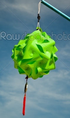 green knot lantern over blue sky