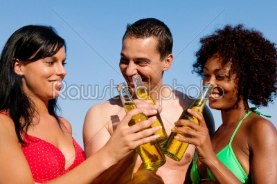 Group of friends drinking beer in swimwear