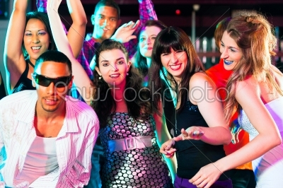 Group of friends in nightclub drinking