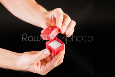 Hand showing red present box