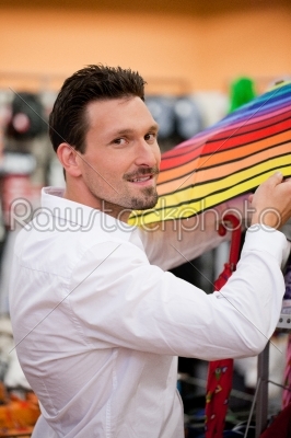 Handsome Man Buying Umbrella at Supermarket
