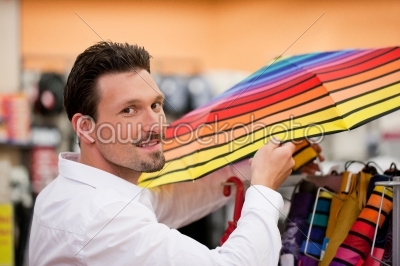 Handsome Man Shopping Umbrella at Supermarket