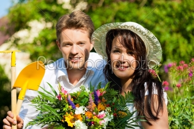 Happy couple gardening in summer