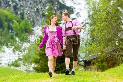 Happy couple hiking in Alpine meadow