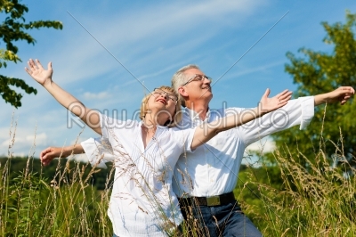 Happy senior couple having fun outdoors in summer