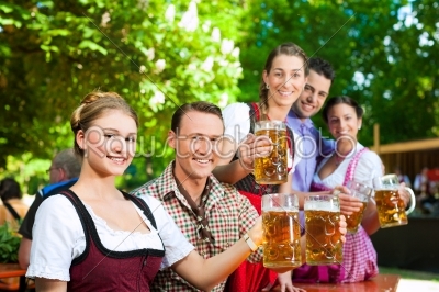 In Beer garden - friends drinking beer